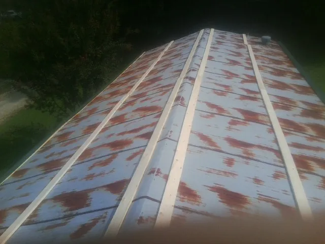 Rusted metal roof panels with new wood purlins before replacement — Storm Damage Roof Repair in Due West by Roofing Brothers
