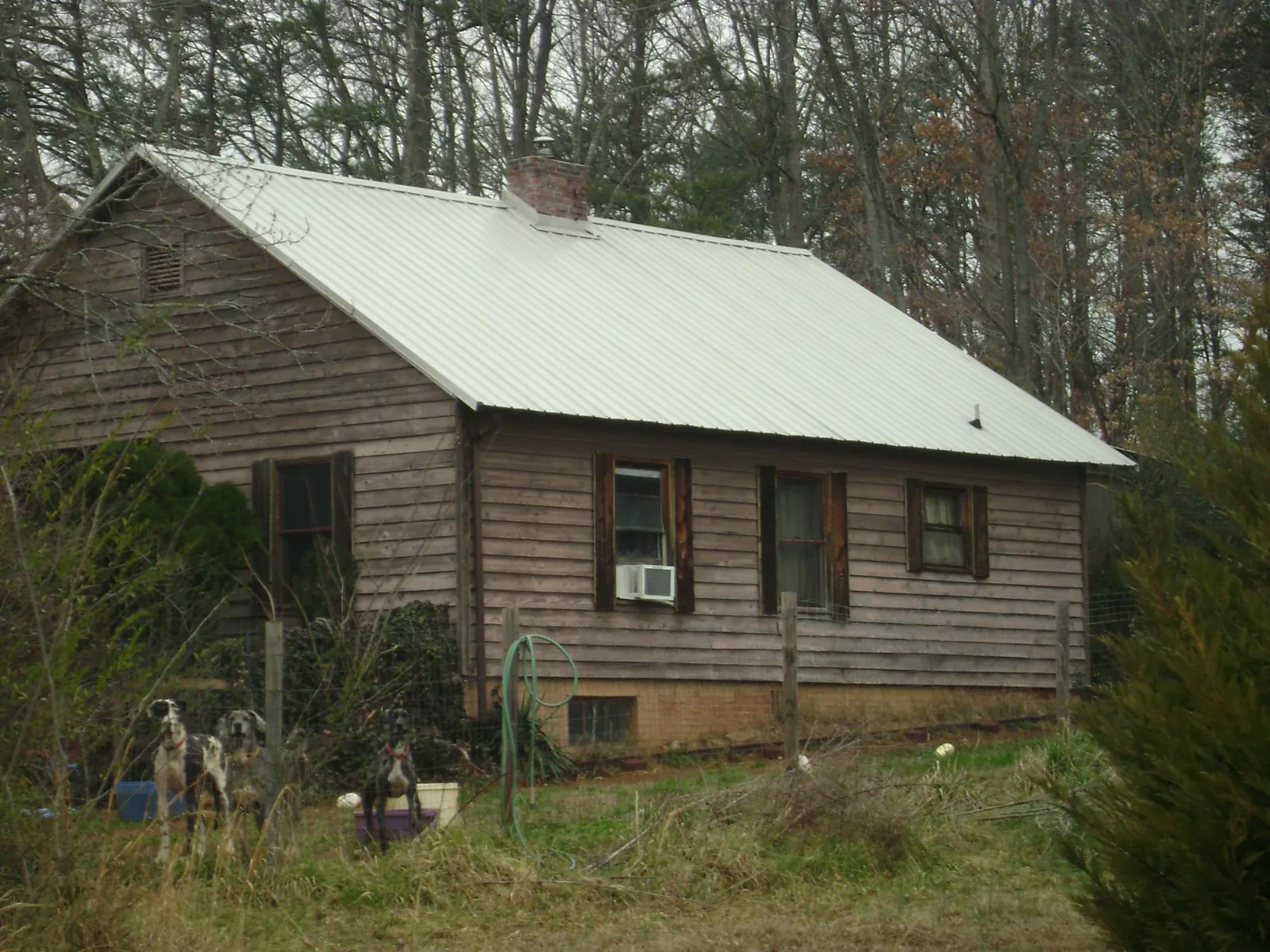 White metal roof on an old wood sided farmhouse, from a Metal Roof Installation job in Due West